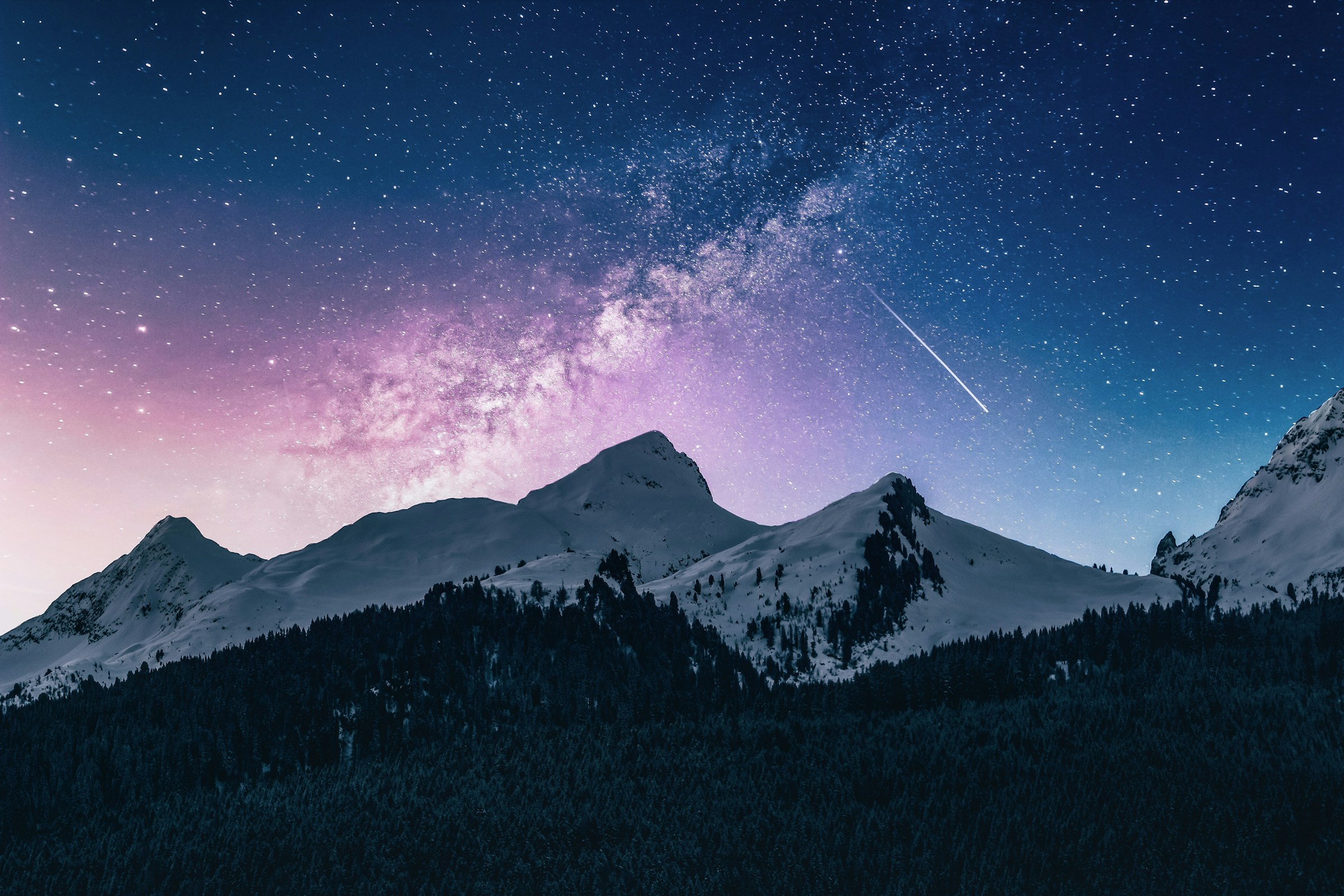 A night sky over mountains representing ambition, scale and responsible progress